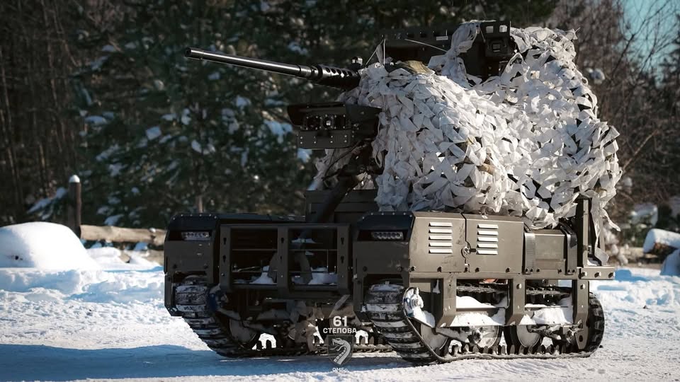 Бойовий наземний роботизований комплекс (НРК) 61-ї окремої механізованої Степової бригади на засніженій позиції. Гусенична платформа оснащена кулеметом і частково вкрита білою маскувальною сіткою
