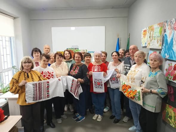 Більшість присутніх одягнені у вишиванки різних кольорів: класичні білі з червоно-чорним орнаментом, сучасні гірчичні, сині та червоні. Вишивка на сорочках різноманітна — від геометричних узорів до пишних квіткових мотивів.