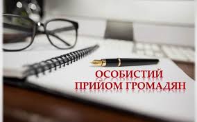 На світлому розмитому фоні робочого столу зображено розгорнутий блокнот на спіралі, поруч із яким лежать окуляри в чорній оправі та класична авторучка, а поверх композиції розміщено великий червоний напис «ОСОБИСТИЙ ПРИЙОМ ГРОМАДЯН»