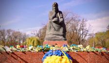 Масивна скульптура жінки, висічена з темного каменю. Вона сидить у глибокій задумі та скорботі, підперши підборіддя правою рукою. Її голова покрита хусткою, а на колінах вона тримає солдатську каску. Поза скульптури передає тихий сум та вшанування пам'яті полеглих.